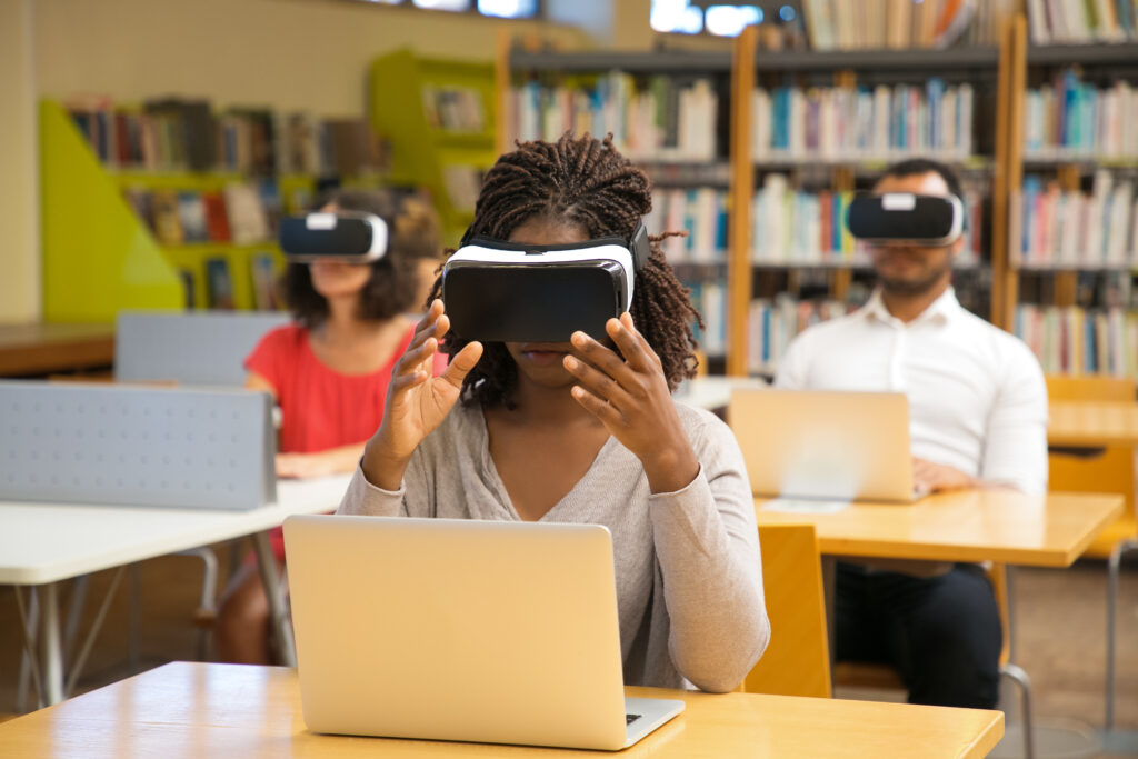 High School Students using VR headsets for immersive learning in modern science curriculum.