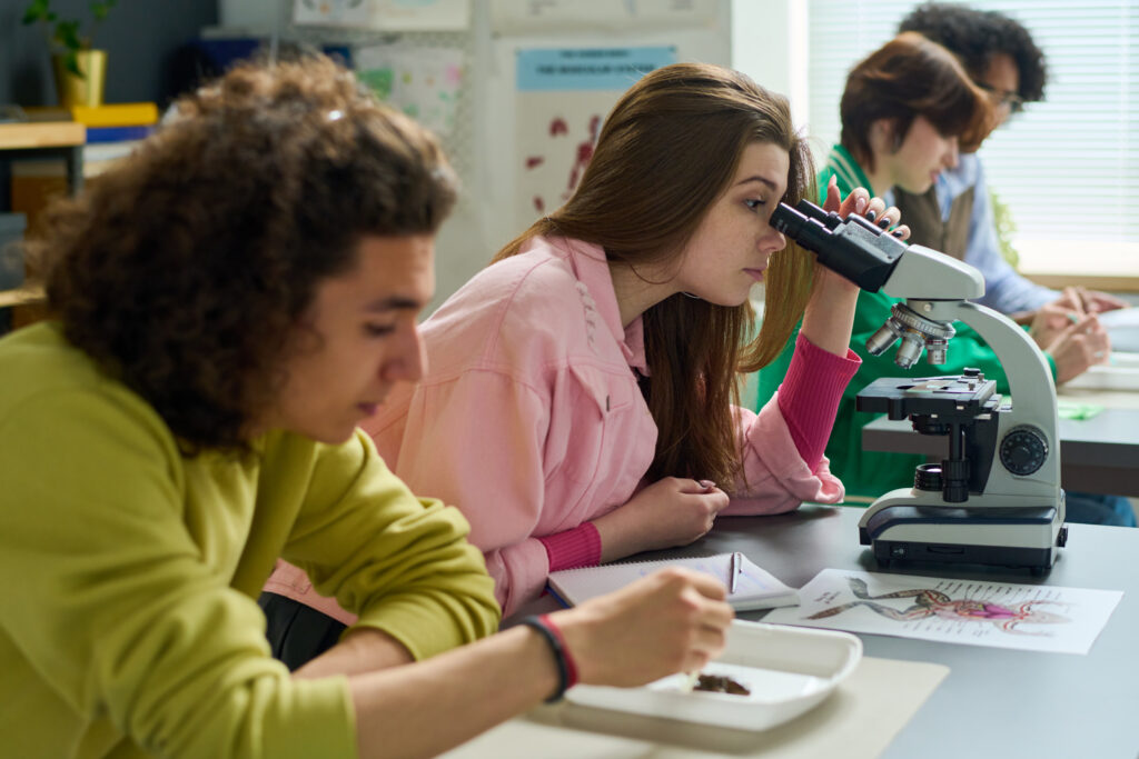 High school students performing lab experiments